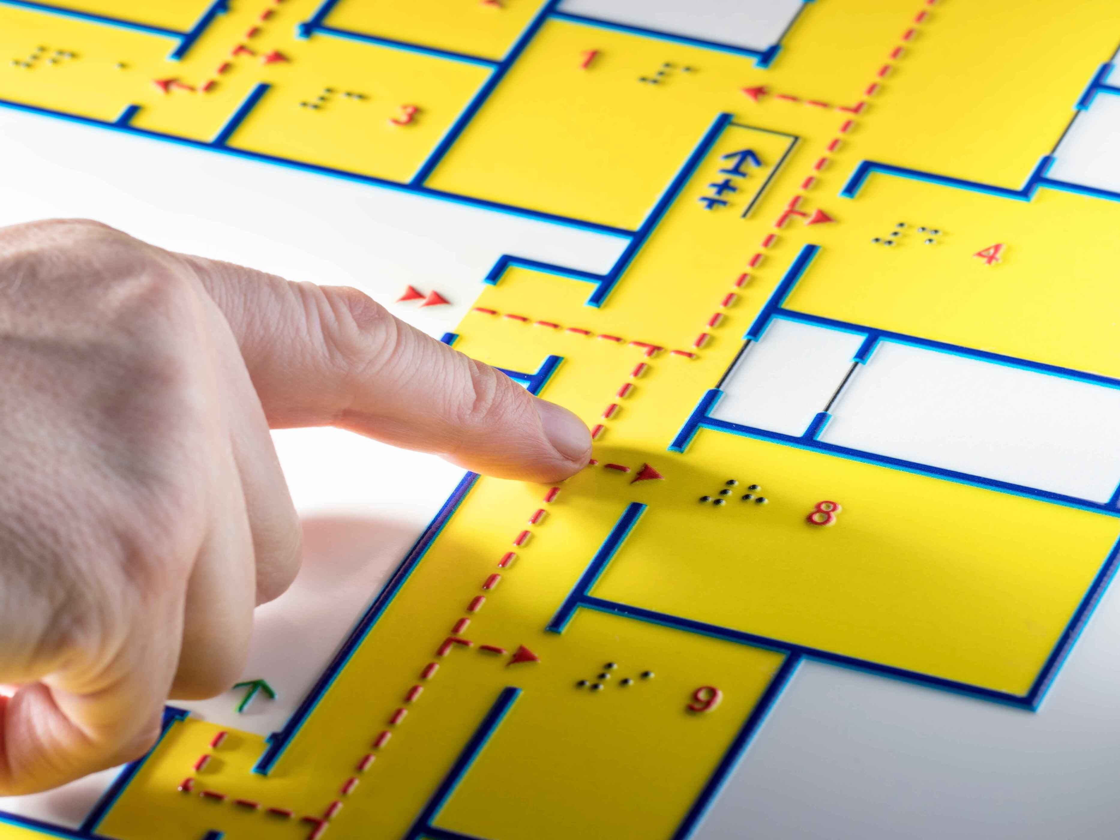 A building floor plan with braille showing hallways and evacuation routes