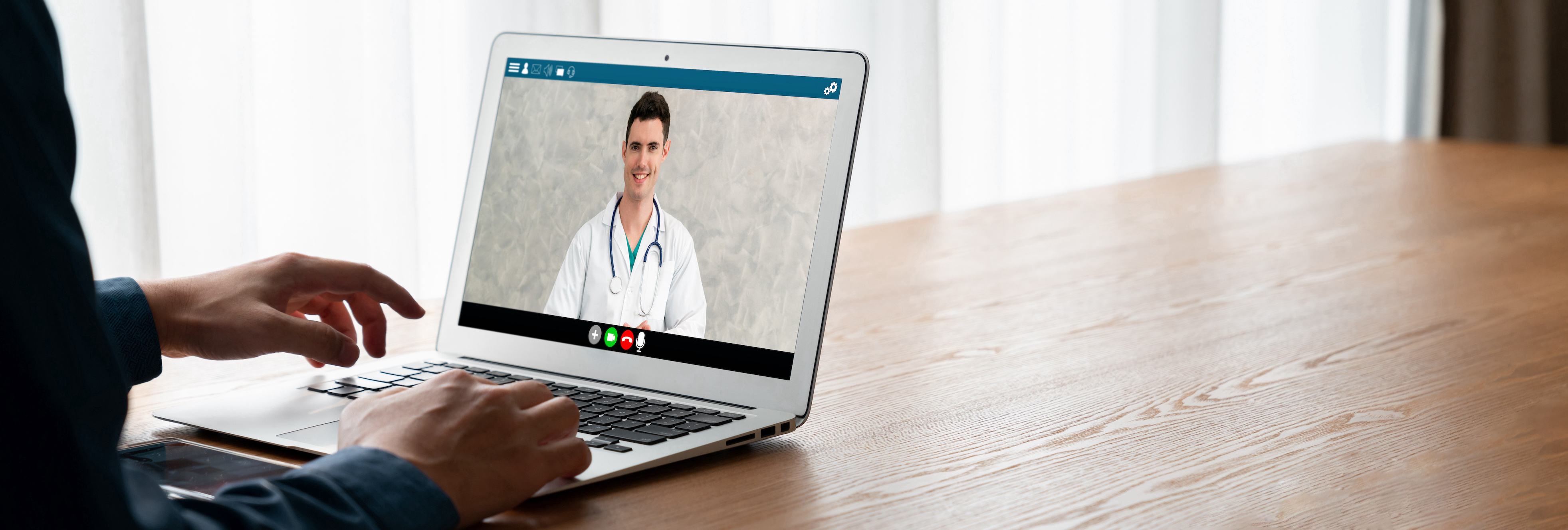 photo of a person on a video call with a doctor