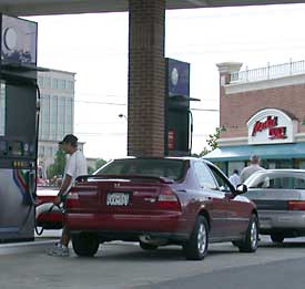 photo of a man pumping self-service gas